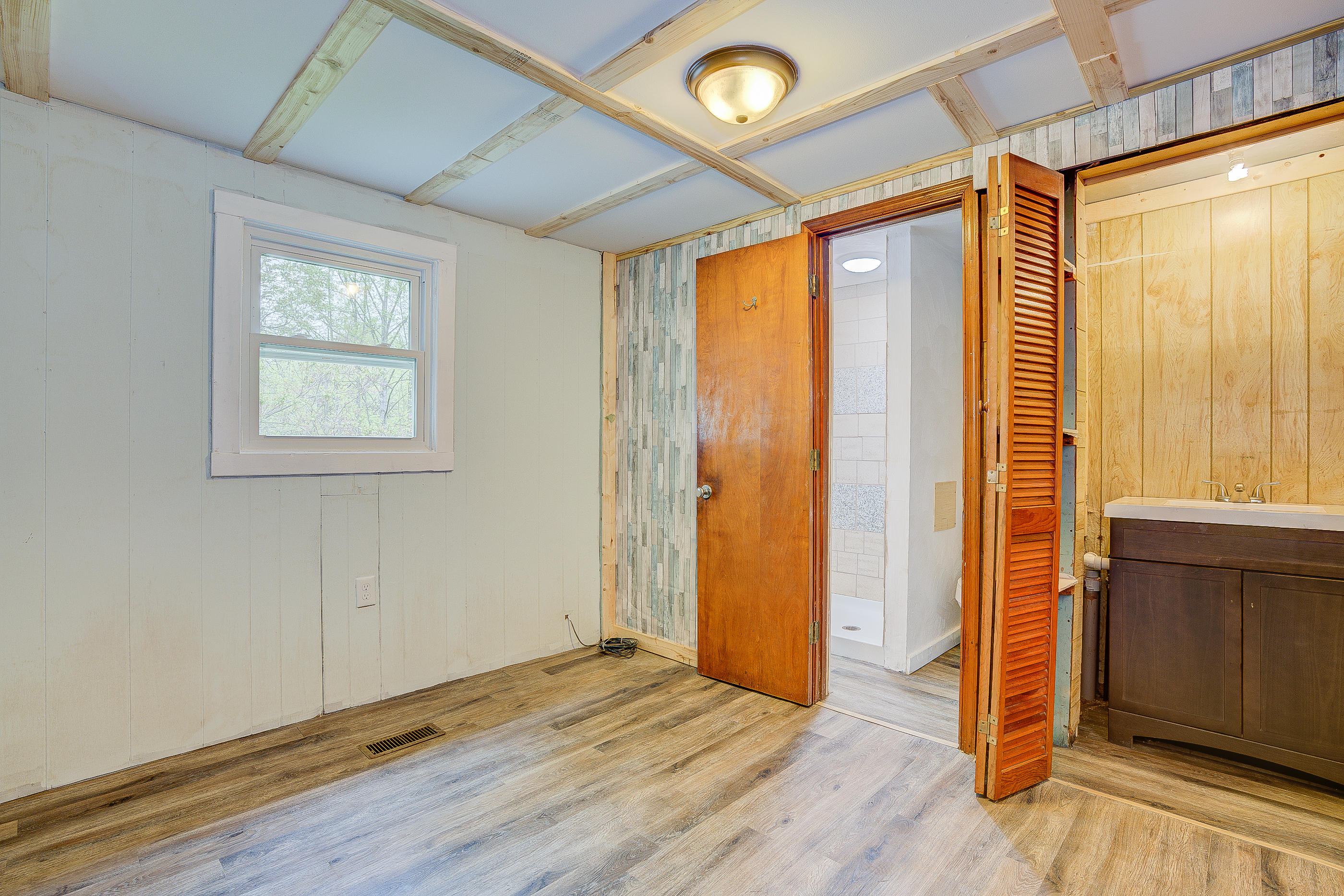 3110 Thomasson Mill Road Goodview, VA 24095 - Photo 18 of 35 an empty room with wooden floor and windows