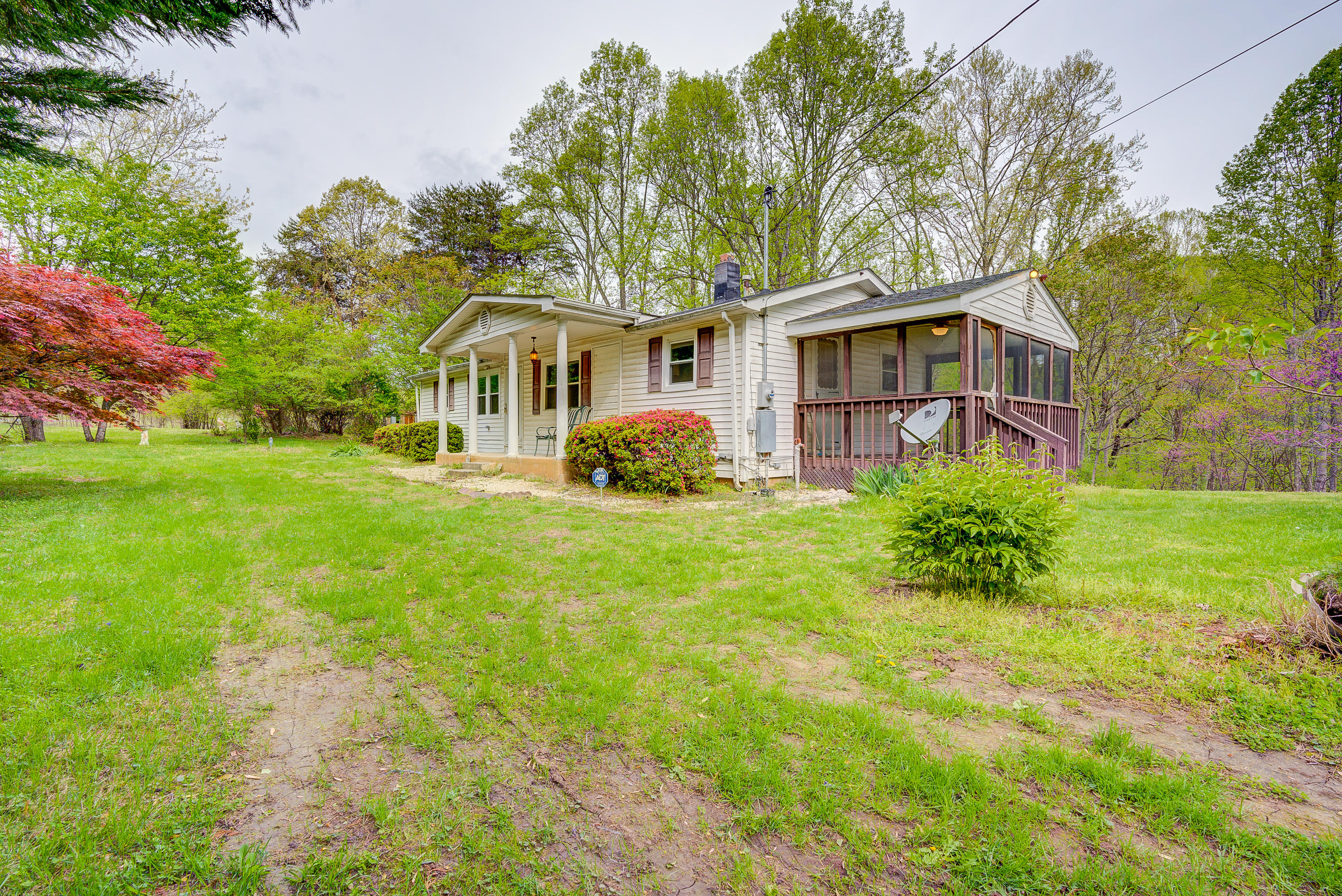 3110 Thomasson Mill Road Goodview, VA 24095 - Photo 3 of 35 a front view of a house with garden