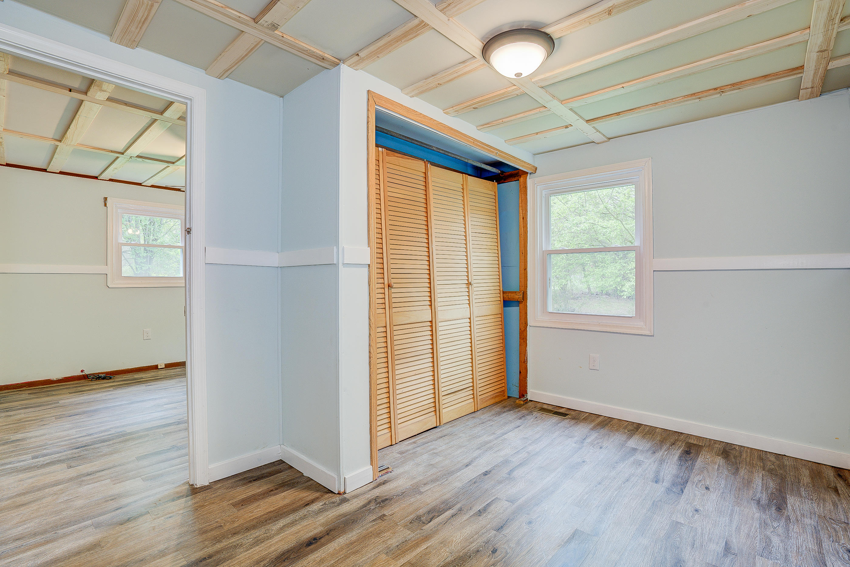 3110 Thomasson Mill Road Goodview, VA 24095 - Photo 24 of 35 an empty room with wooden floor and windows
