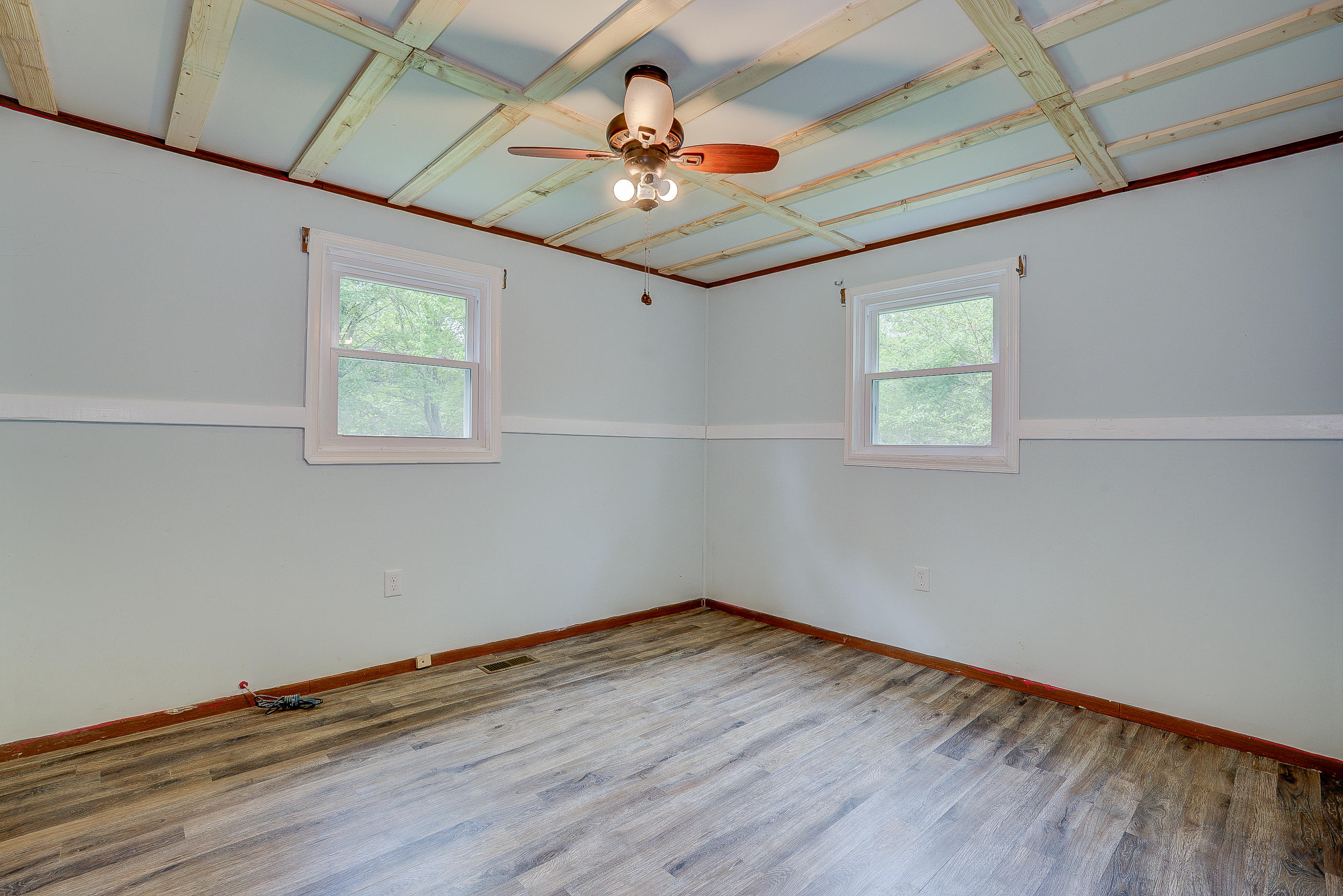3110 Thomasson Mill Road Goodview, VA 24095 - Photo 26 of 35 a room with wooden floor chandelier and window