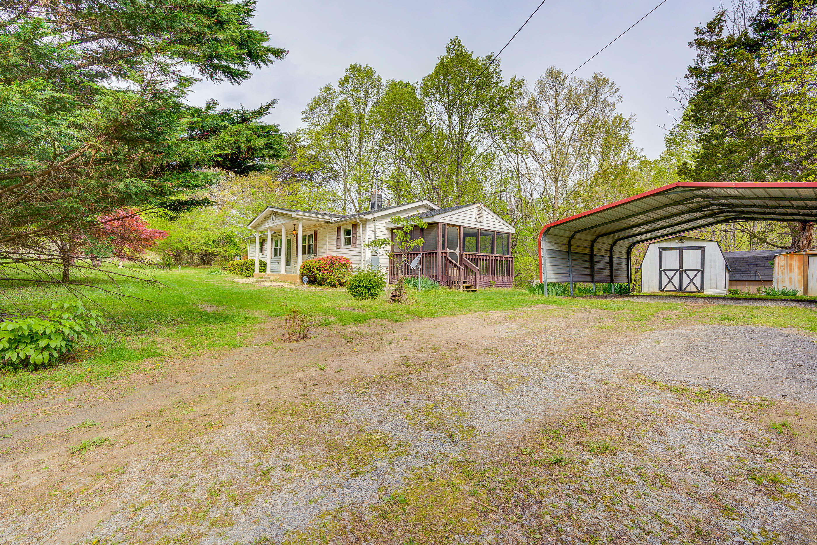3110 Thomasson Mill Road Goodview, VA 24095 - Photo 28 of 35 a house with garden in front of it