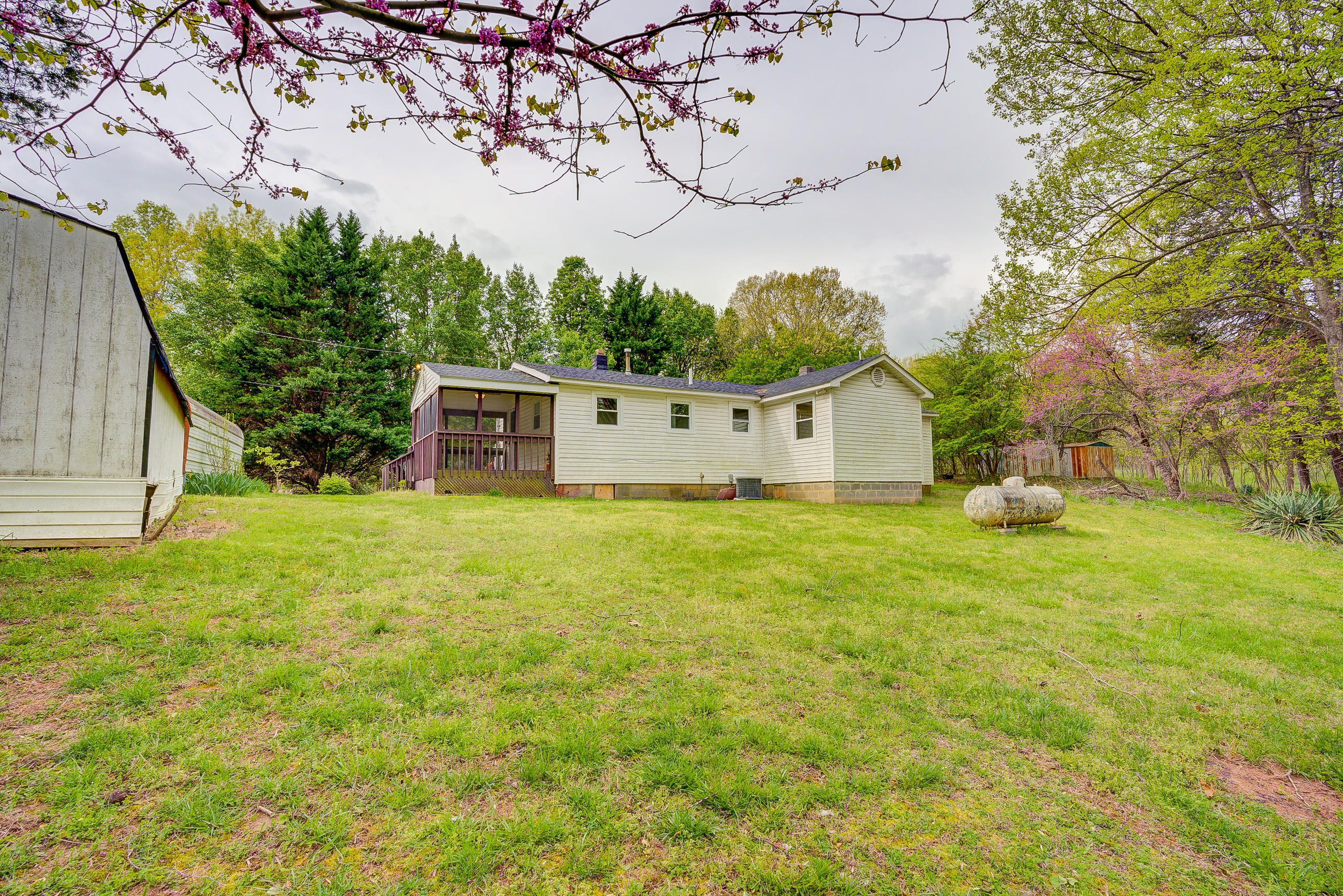 3110 Thomasson Mill Road Goodview, VA 24095 - Photo 35 of 35 a front view of house with yard and trees in the background