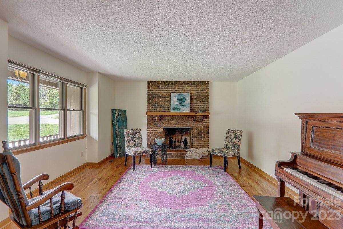 110 Oak Hill Road Candler, NC 28715 - Photo 18 of 37 a living room with furniture and a fireplace