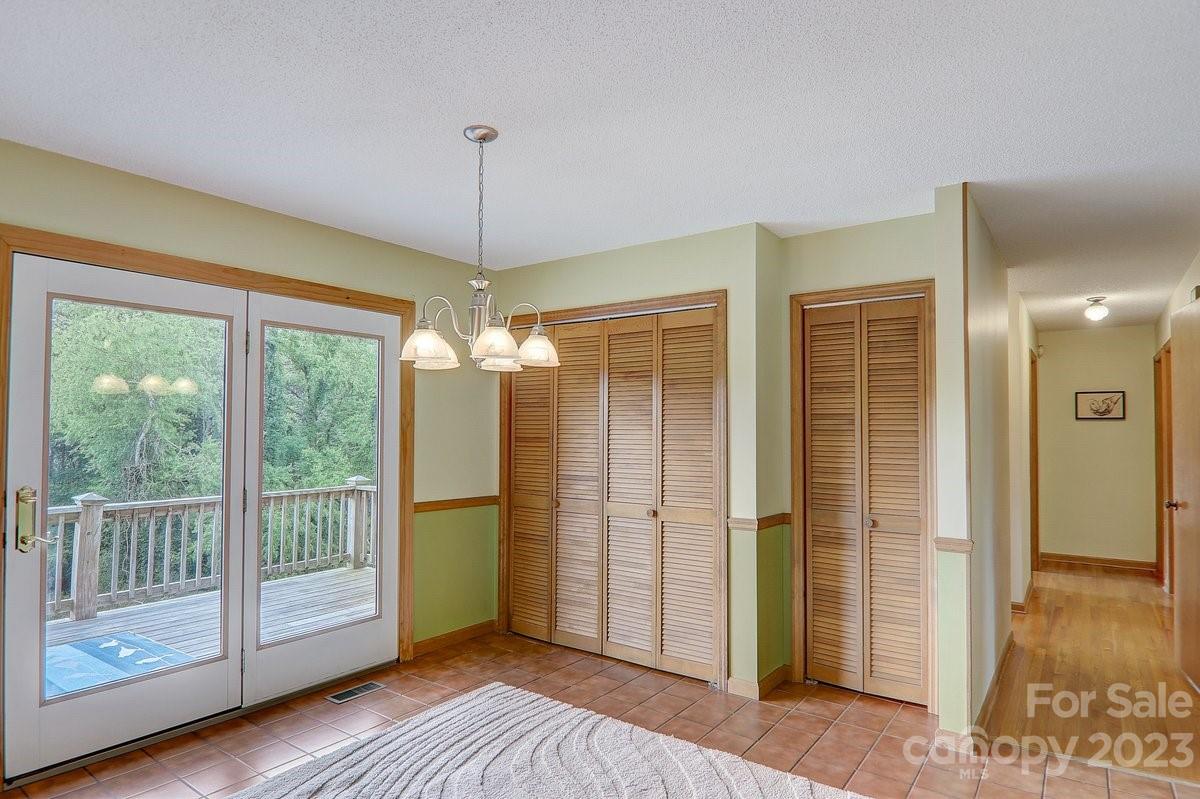 110 Oak Hill Road Candler, NC 28715 - Photo 25 of 37 a view of a room with wooden floor large windows and outdoor view