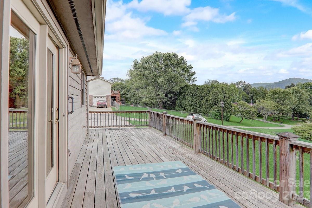 110 Oak Hill Road Candler, NC 28715 - Photo 3 of 37 a view of a balcony with wooden floor and fence