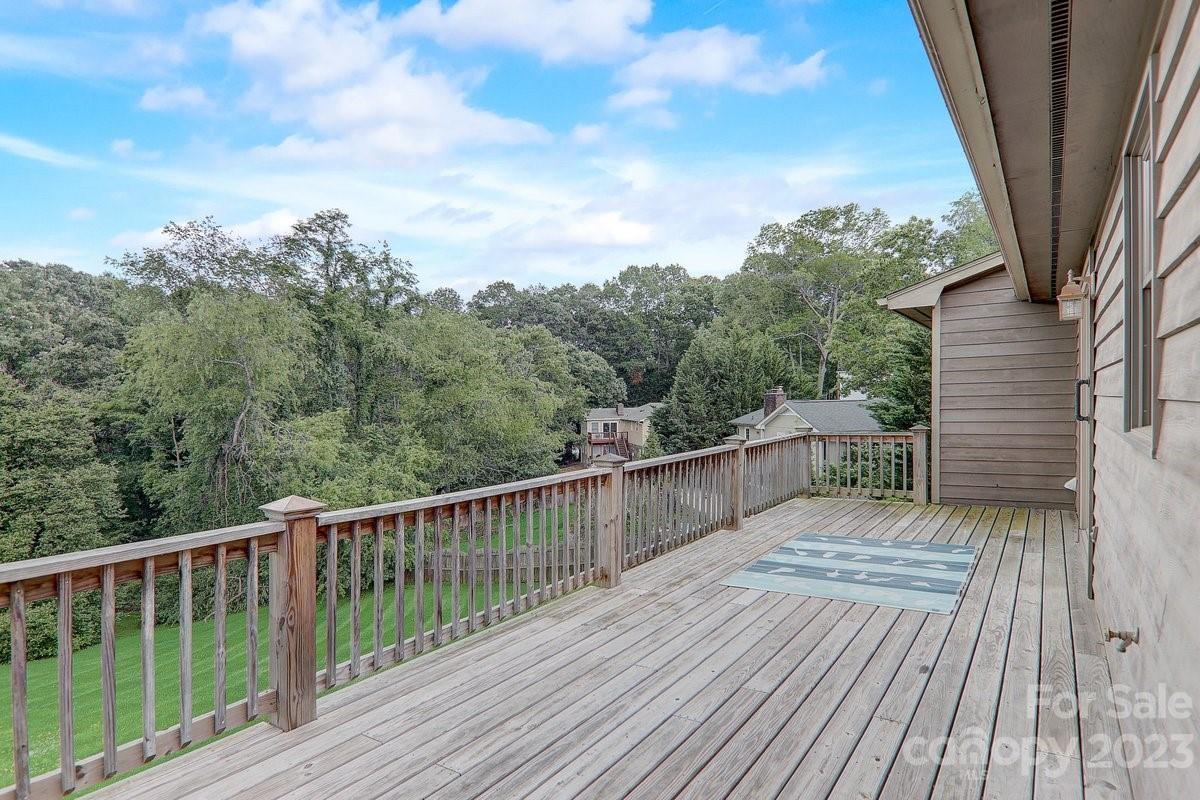110 Oak Hill Road Candler, NC 28715 - Photo 4 of 37 a balcony with wooden floor and fence