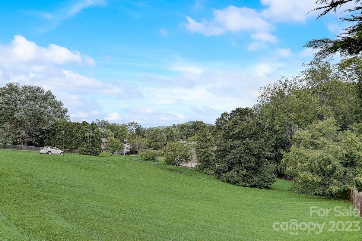 110 Oak Hill Road Candler, NC 28715 - Photo 5 of 37 a view of a grassy field with an trees