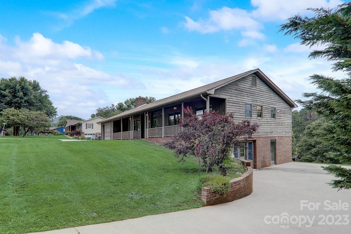 110 Oak Hill Road Candler, NC 28715 - Photo 7 of 37 a front view of a house with a garden