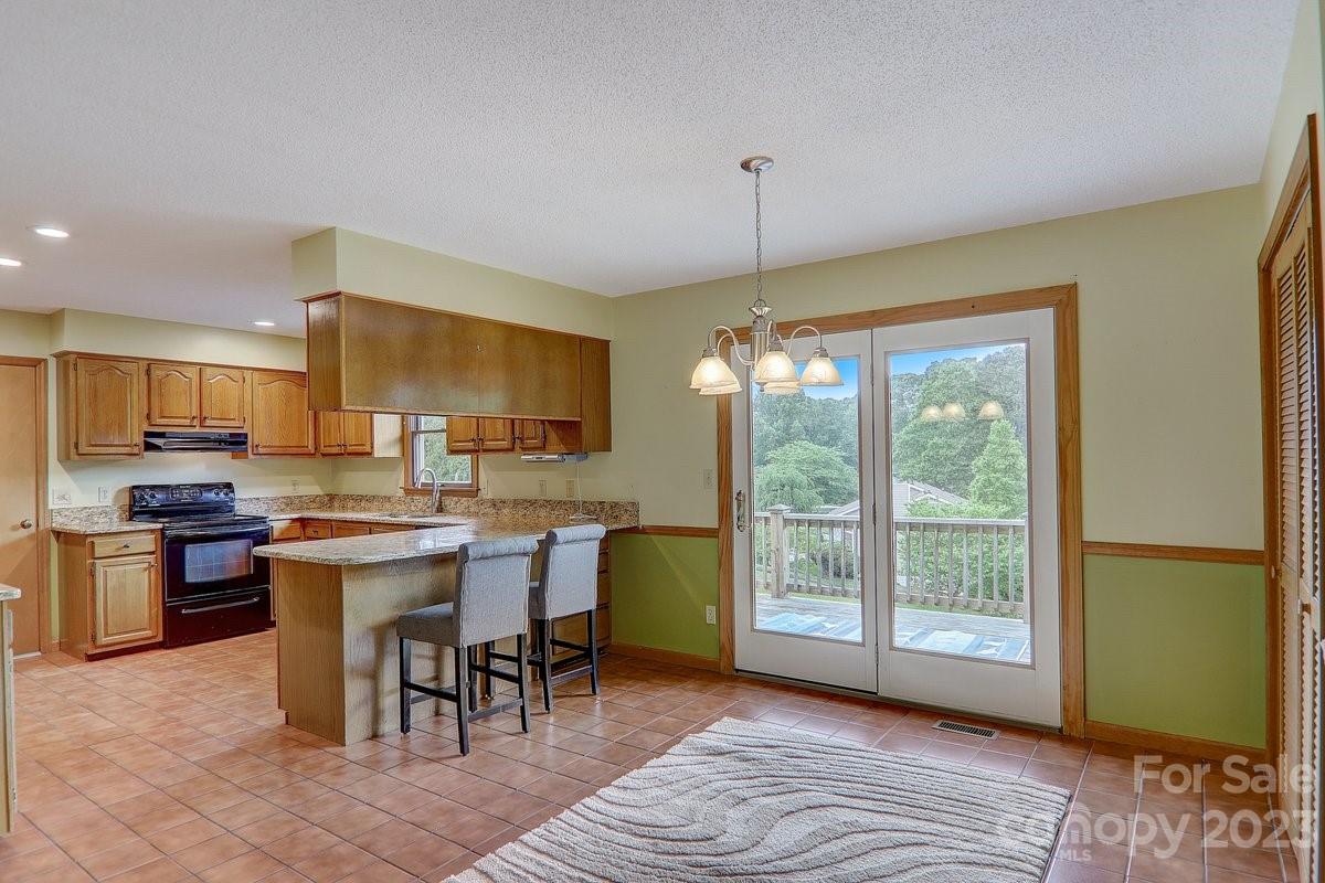 110 Oak Hill Road Candler, NC 28715 - Photo 9 of 37 a kitchen with kitchen island a large window in it and kitchen island