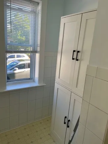 a bathroom with a shower and a window