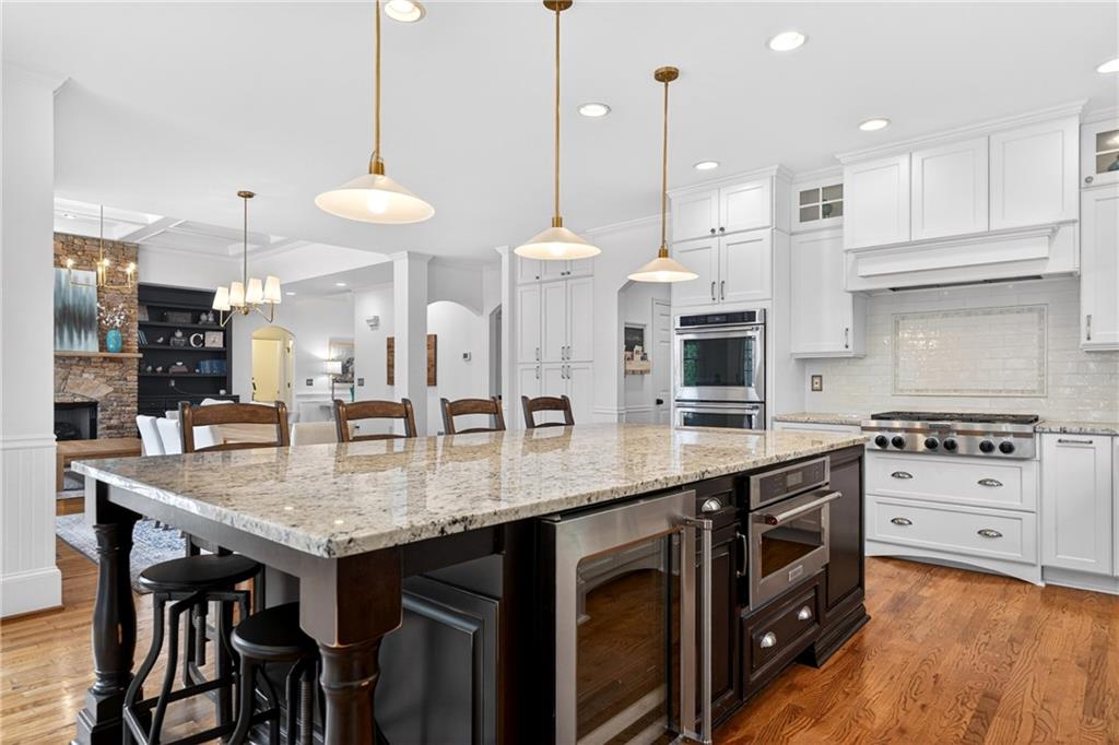 130 Providence Oaks Pointe Milton, GA 30004 - Photo 30 of 89 a kitchen with stainless steel appliances granite countertop a stove a sink a oven a dining table and chairs