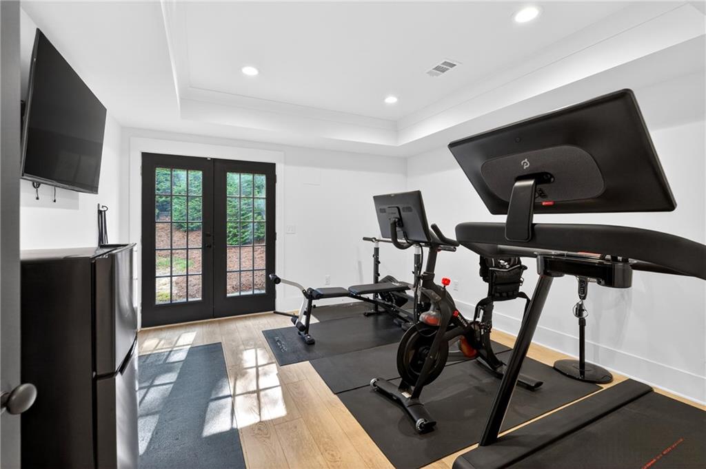 130 Providence Oaks Pointe Milton, GA 30004 - Photo 73 of 89 a living room with gym equipment and a flat screen tv