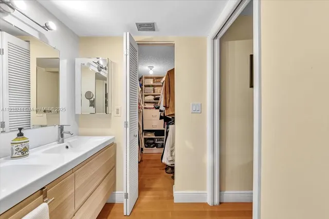 a bathroom with a sink shower and a toilet
