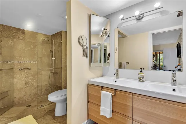 a bathroom with a shower and a glass door