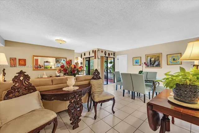 a view of a dining room with furniture a rug and wooden floor