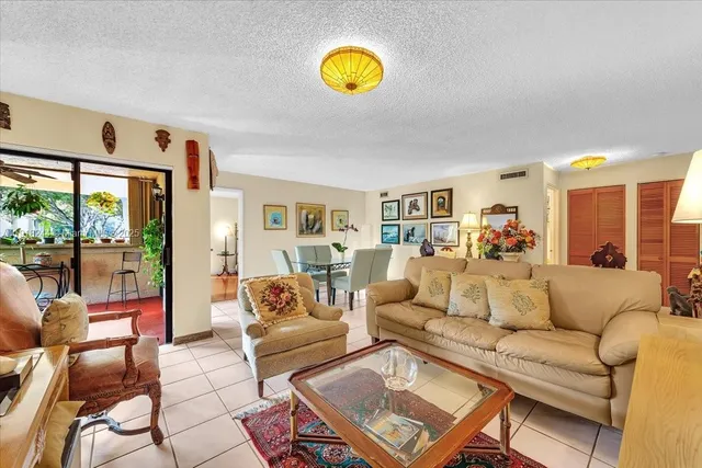 a living room with furniture and a potted plant