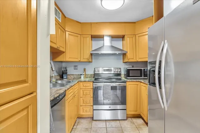 a kitchen with stainless steel appliances granite countertop a sink and cabinets