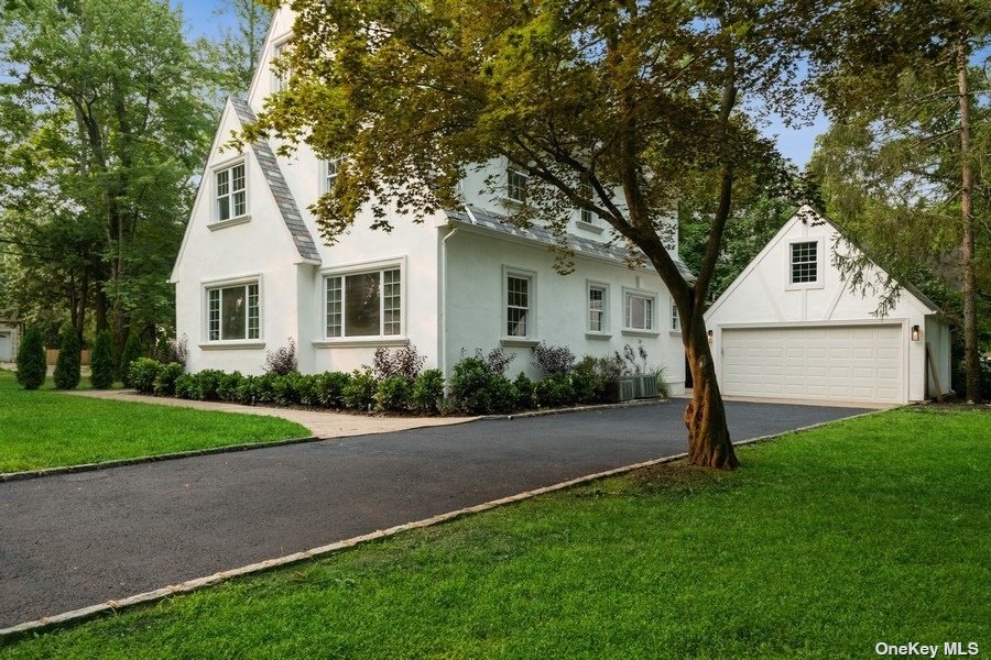 40 Kings Point Road Great Neck, NY 11024 - Photo 1 of 1 a front view of a house with a yard and garage