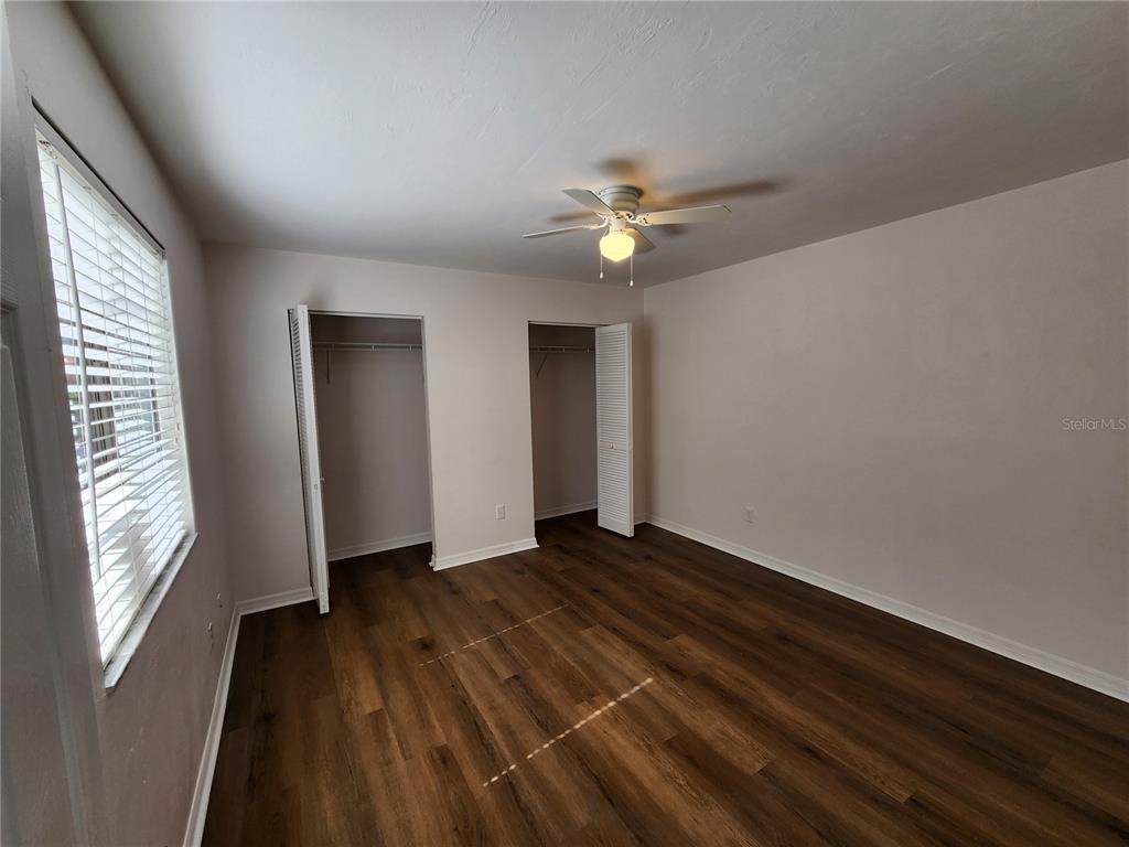 5823 Southwest 9th Place, Unit H55 Gainesville, FL 32607 - Photo 6 of 50 wooden floor in an empty room with a window