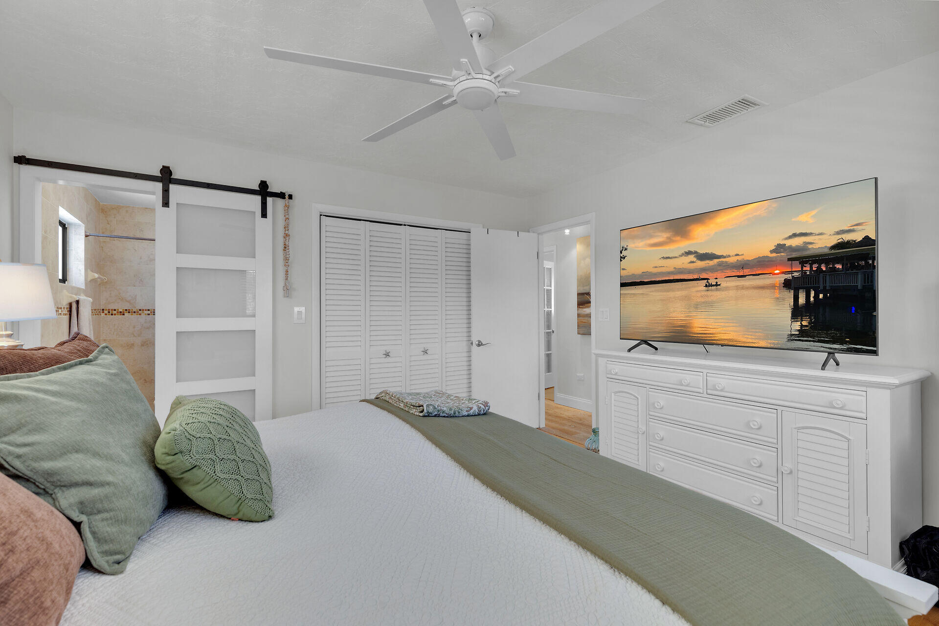 782 Bostwick Drive Key Largo, FL 33037 - Photo 29 of 63 a bedroom with a bed and a flat screen tv