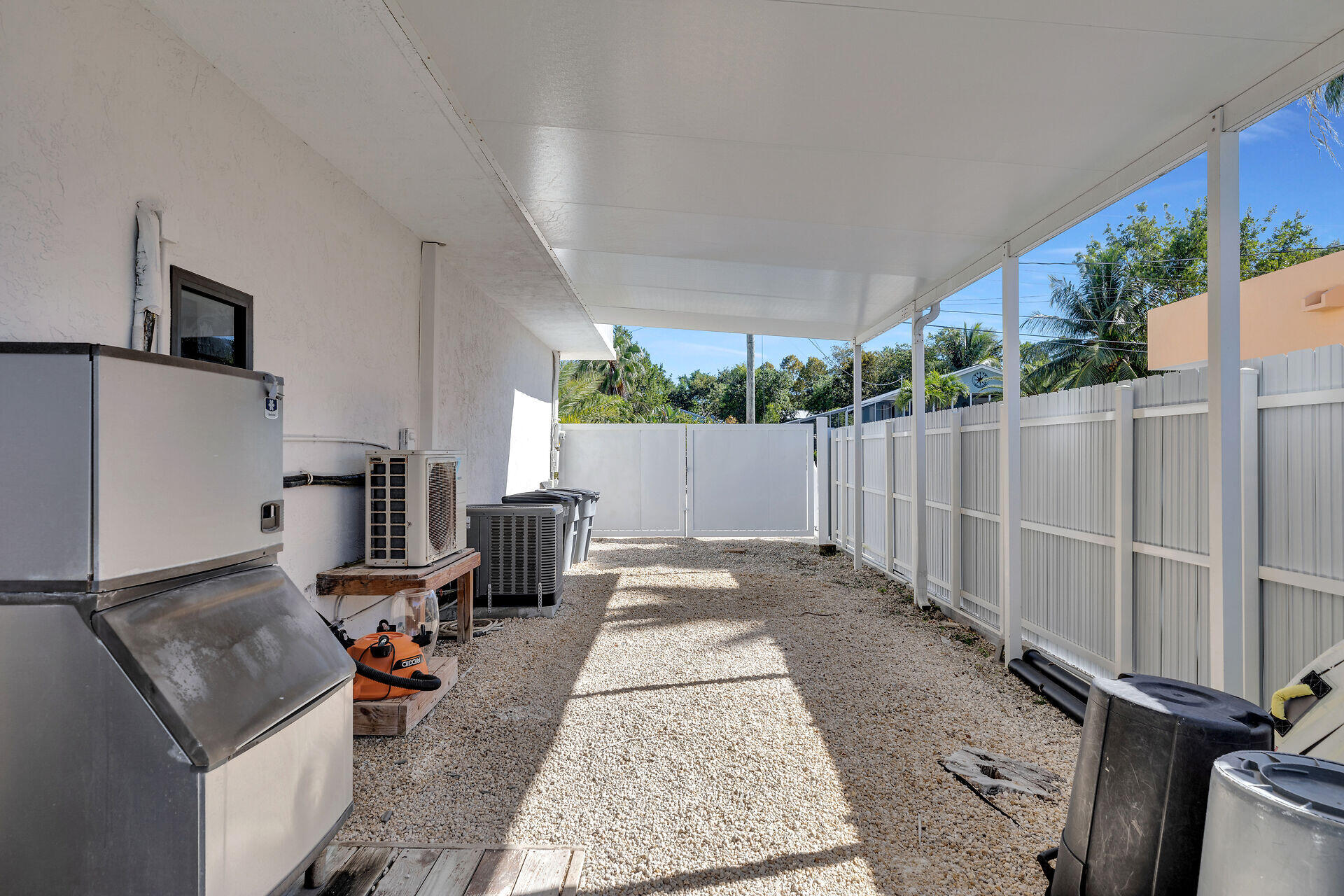 782 Bostwick Drive Key Largo, FL 33037 - Photo 53 of 63 a view of a backyard with chairs and a wooden fence