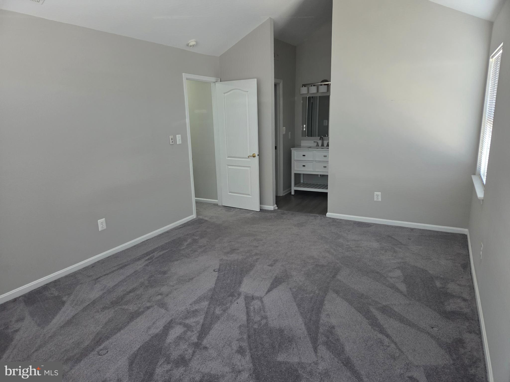 8343 Montgomery Run Road Ellicott City, MD 21043 - Photo 18 of 36 Spacious room with soft gray tones.