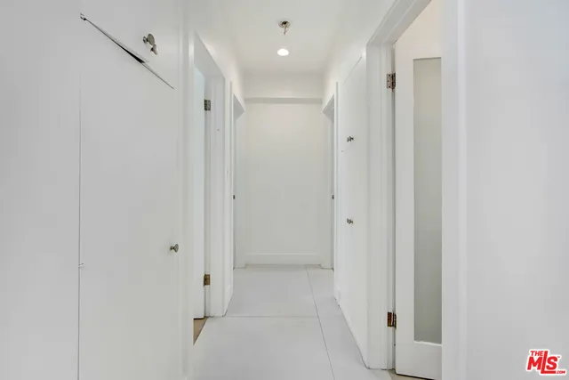 a bedroom with a bed mirror and window