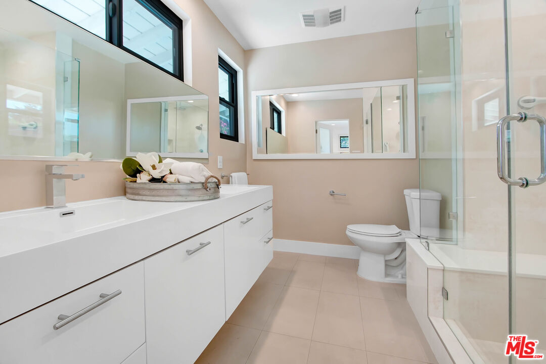 4166 Crisp Canyon Road Sherman Oaks, CA 91403 - Photo 28 of 54 a bathroom with a sink a toilet and mirror