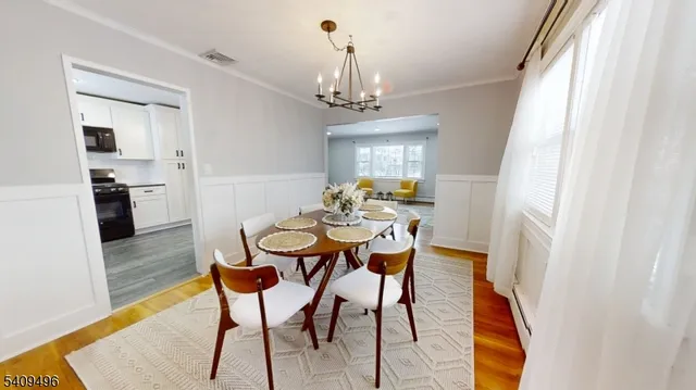 a view of a dining room with furniture and chandelier
