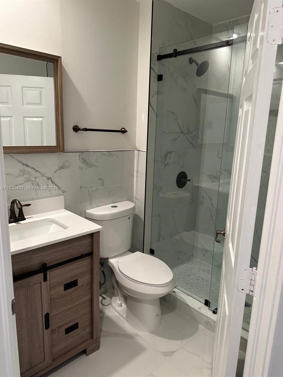 12421 Southwest 50th Court, Unit 337 Miramar, FL 33027 - Photo 34 of 46 a bathroom with a sink a toilet and shower