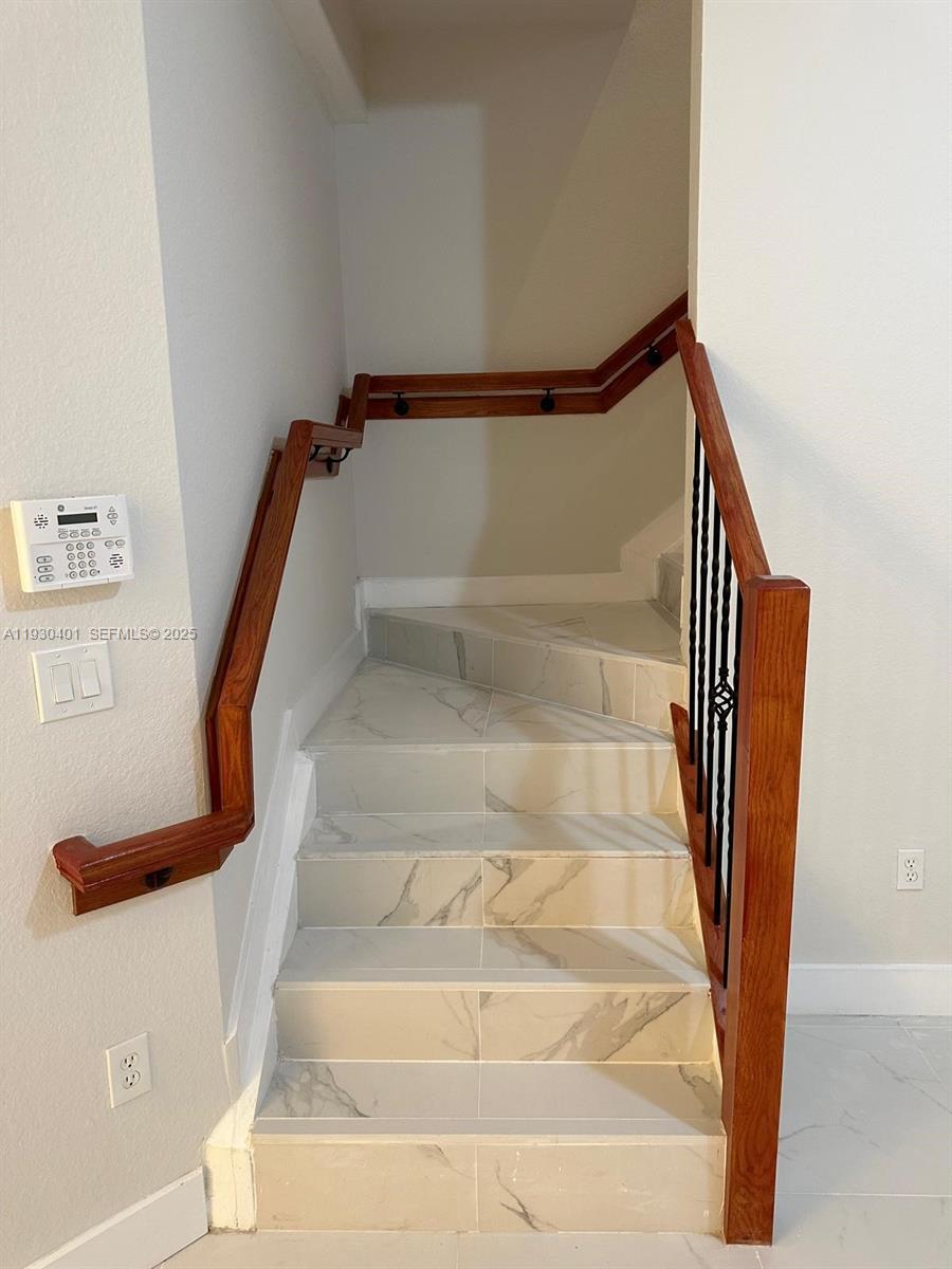 12421 Southwest 50th Court, Unit 337 Miramar, FL 33027 - Photo 10 of 46 a view of staircase with white walls and railing