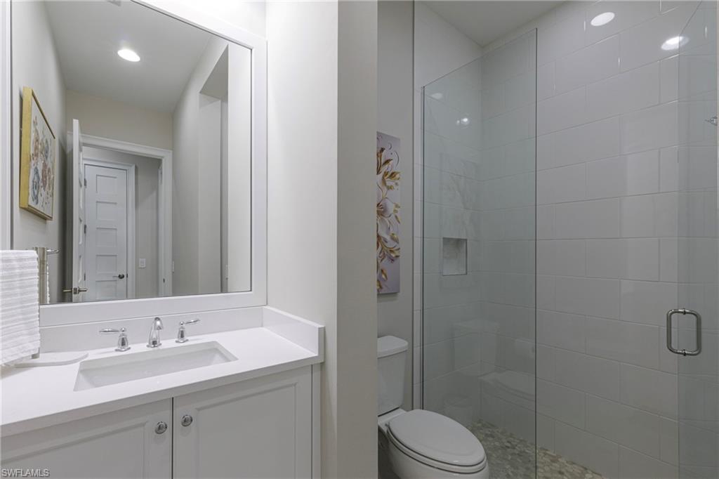 8909 Yucatan Court Naples, FL 34113 - Photo 16 of 36 Bathroom with a stall shower, vanity, and recessed lighting
