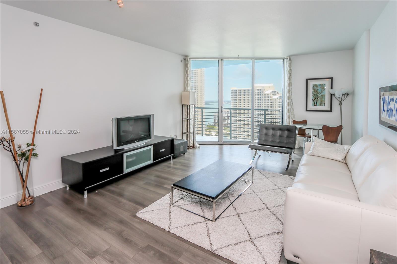 335 South Biscayne Boulevard, Unit 2703 Miami, FL 33131 - Photo 3 of 55 a living room with furniture and a flat screen tv