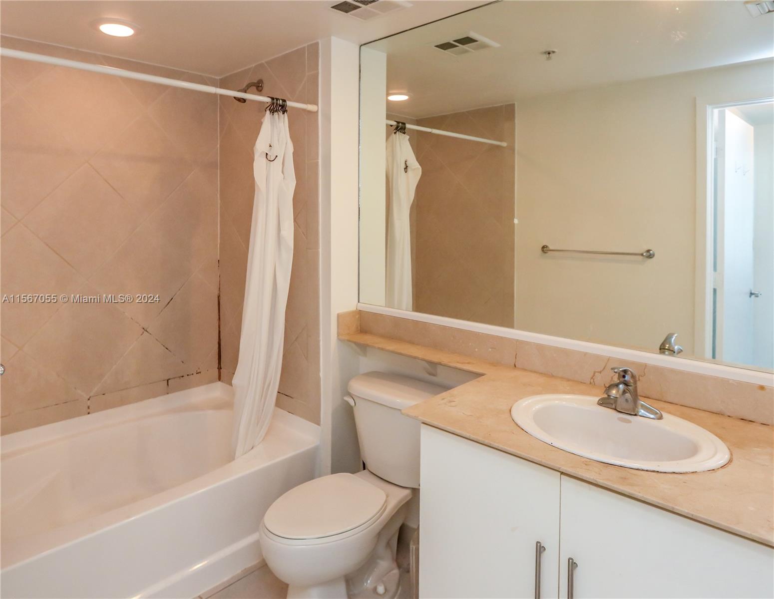 335 South Biscayne Boulevard, Unit 2703 Miami, FL 33131 - Photo 9 of 55 a bathroom with a sink toilet and shower