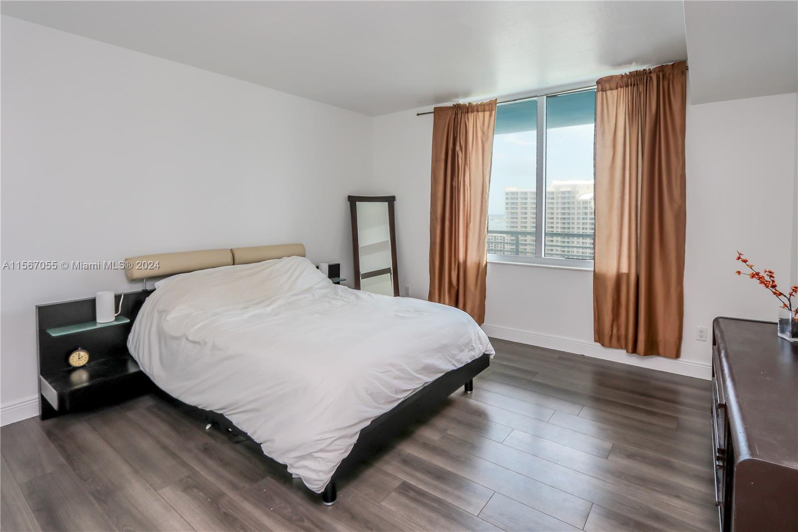 335 South Biscayne Boulevard, Unit 2703 Miami, FL 33131 - Photo 10 of 55 a bed sitting in a bedroom next to a window