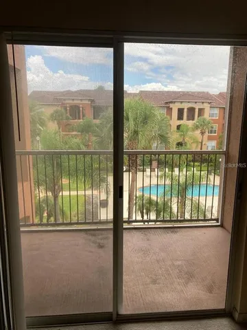 a view of a glass door with a yard