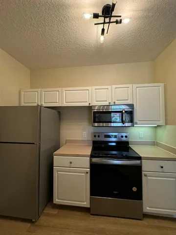 a kitchen with a stove and a refrigerator