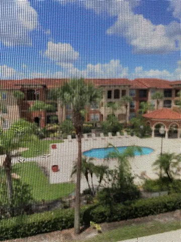a kitchen with a sink cabinets stainless steel appliances and a counter top space