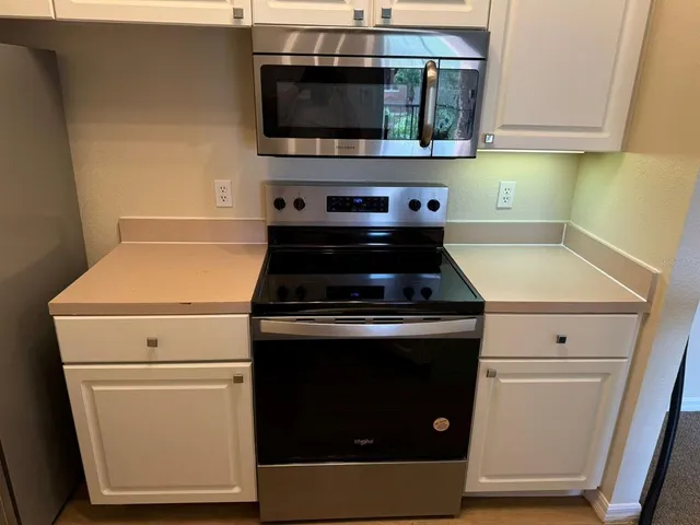 a kitchen with a stove and a microwave