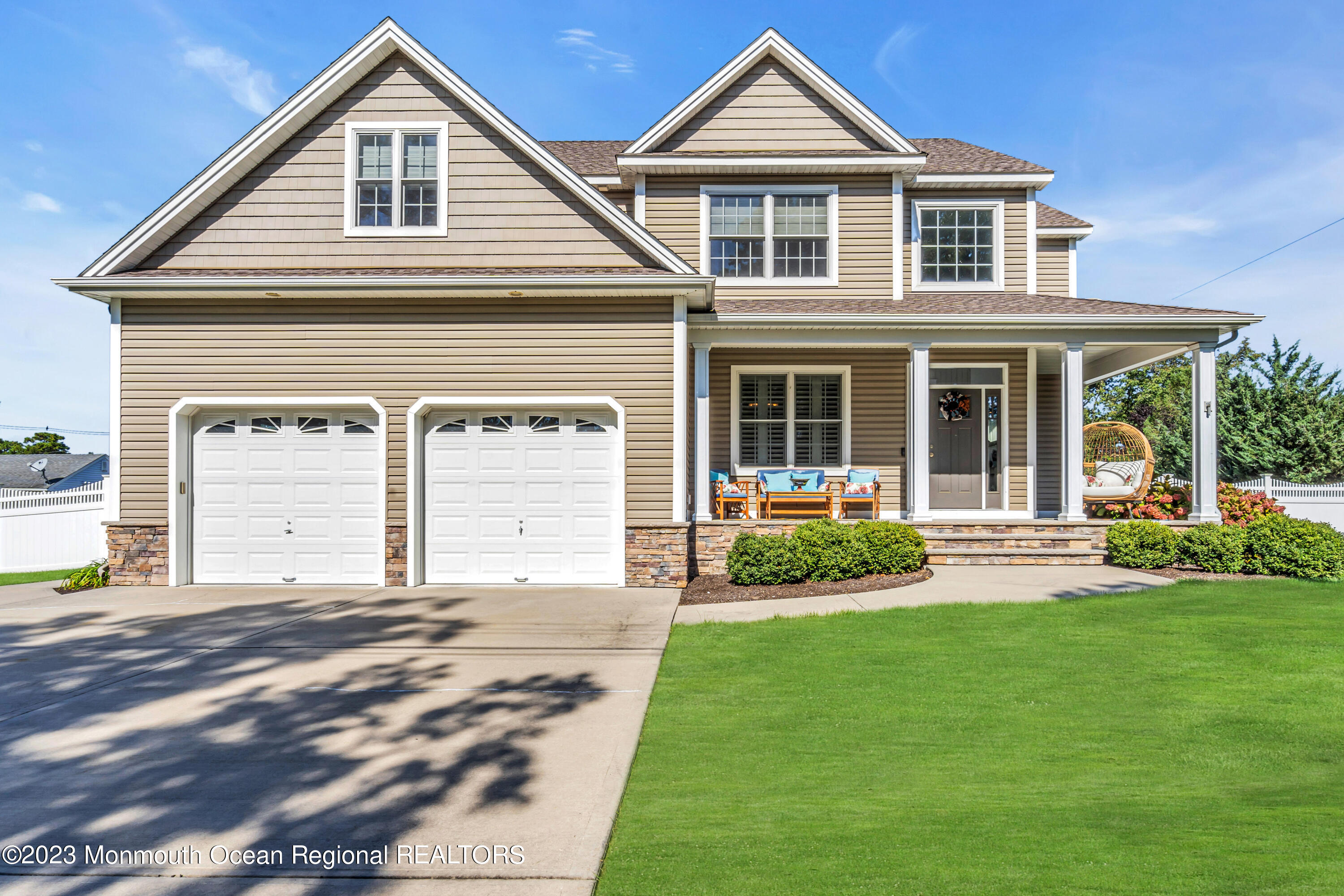 304 Wayne Avenue Pine Beach, NJ 08741 - Photo 1 of 94 a front view of a house with a yard and garage