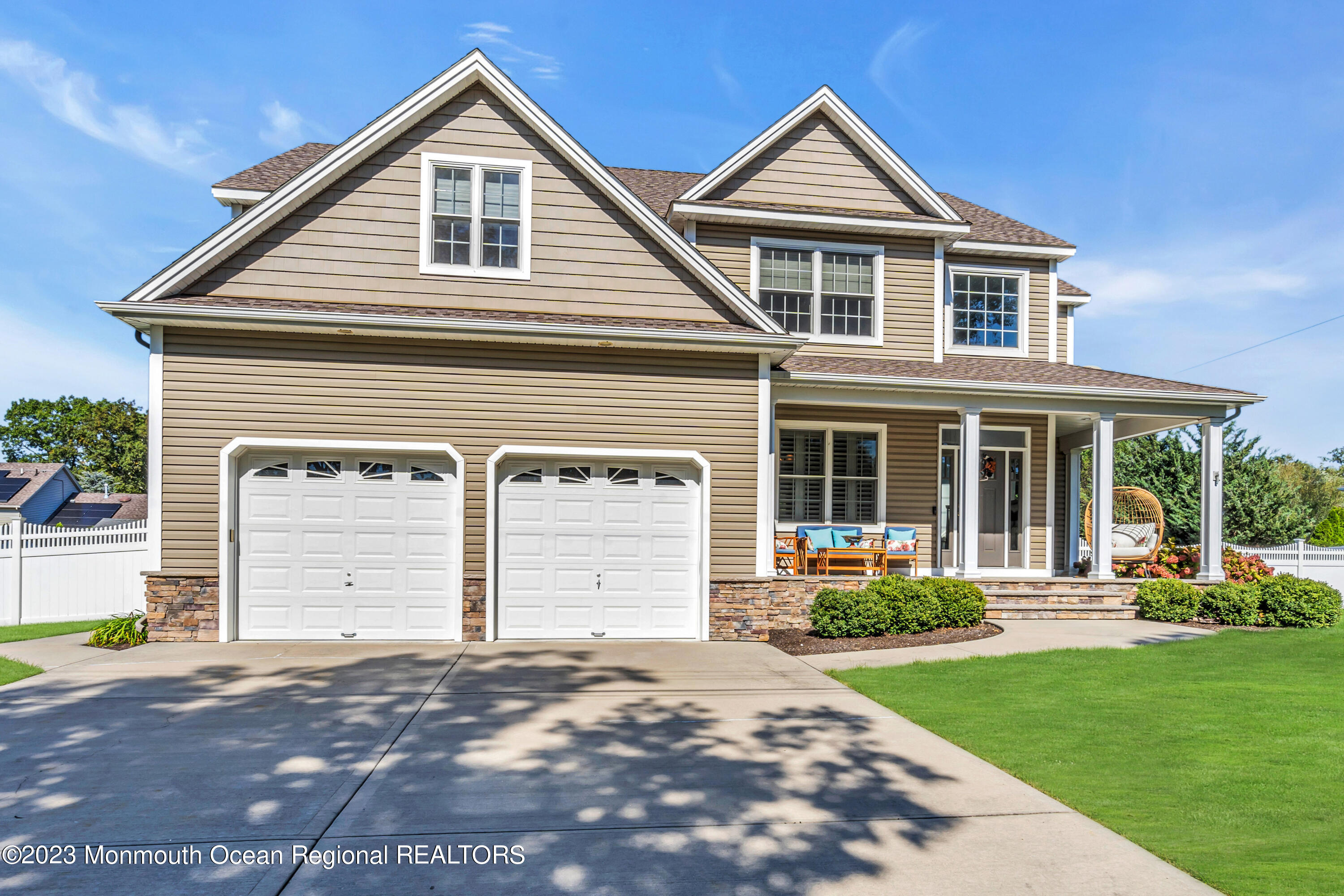 304 Wayne Avenue Pine Beach, NJ 08741 - Photo 2 of 94 a front view of a house with a yard and garage