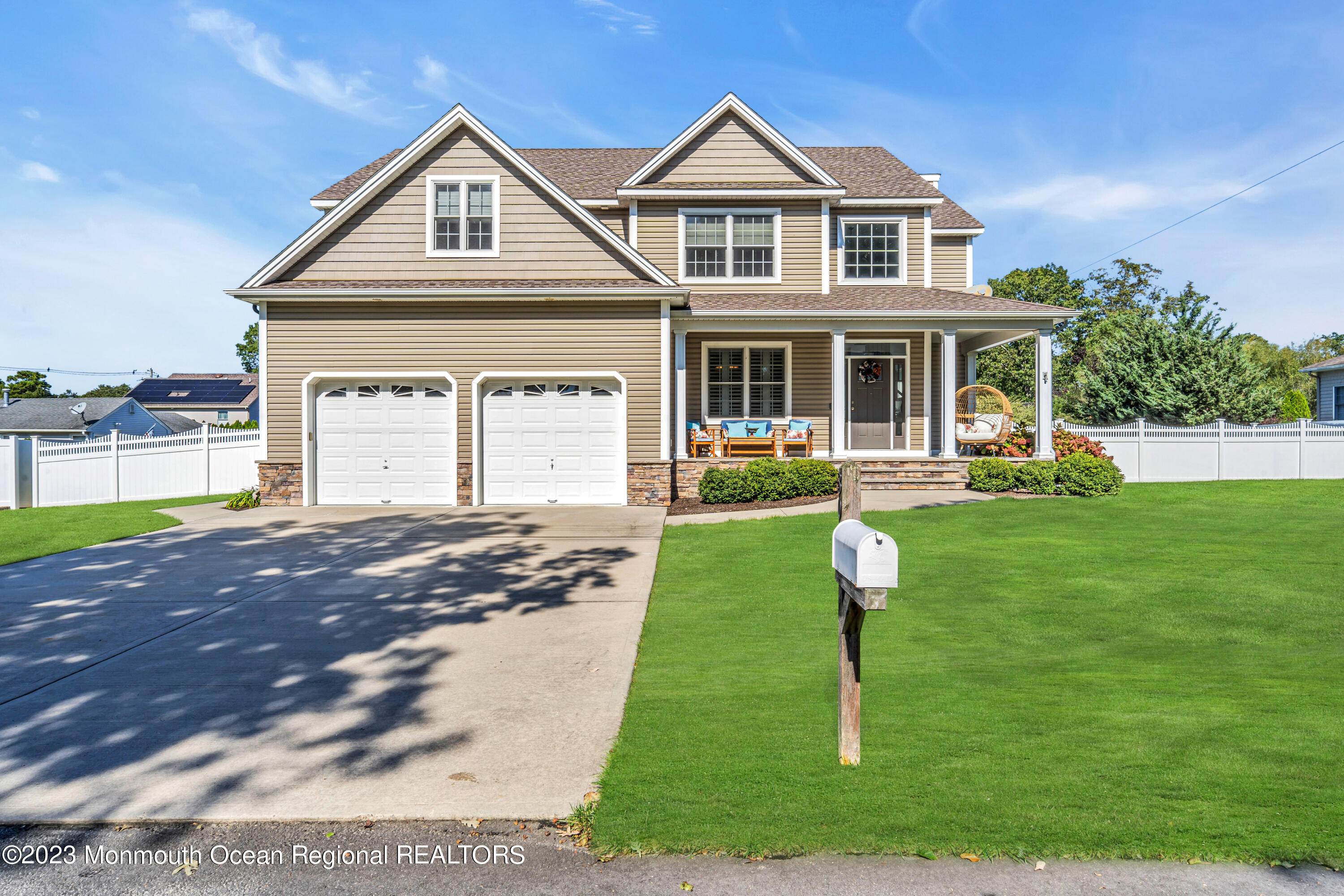 304 Wayne Avenue Pine Beach, NJ 08741 - Photo 5 of 94 a front view of a house with a yard and trees