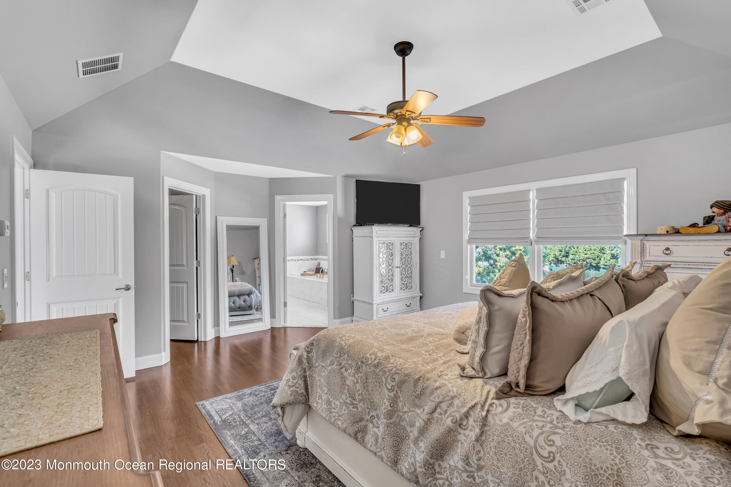 304 Wayne Avenue Pine Beach, NJ 08741 - Photo 66 of 94 a bedroom with a bed a dresser and a chandelier