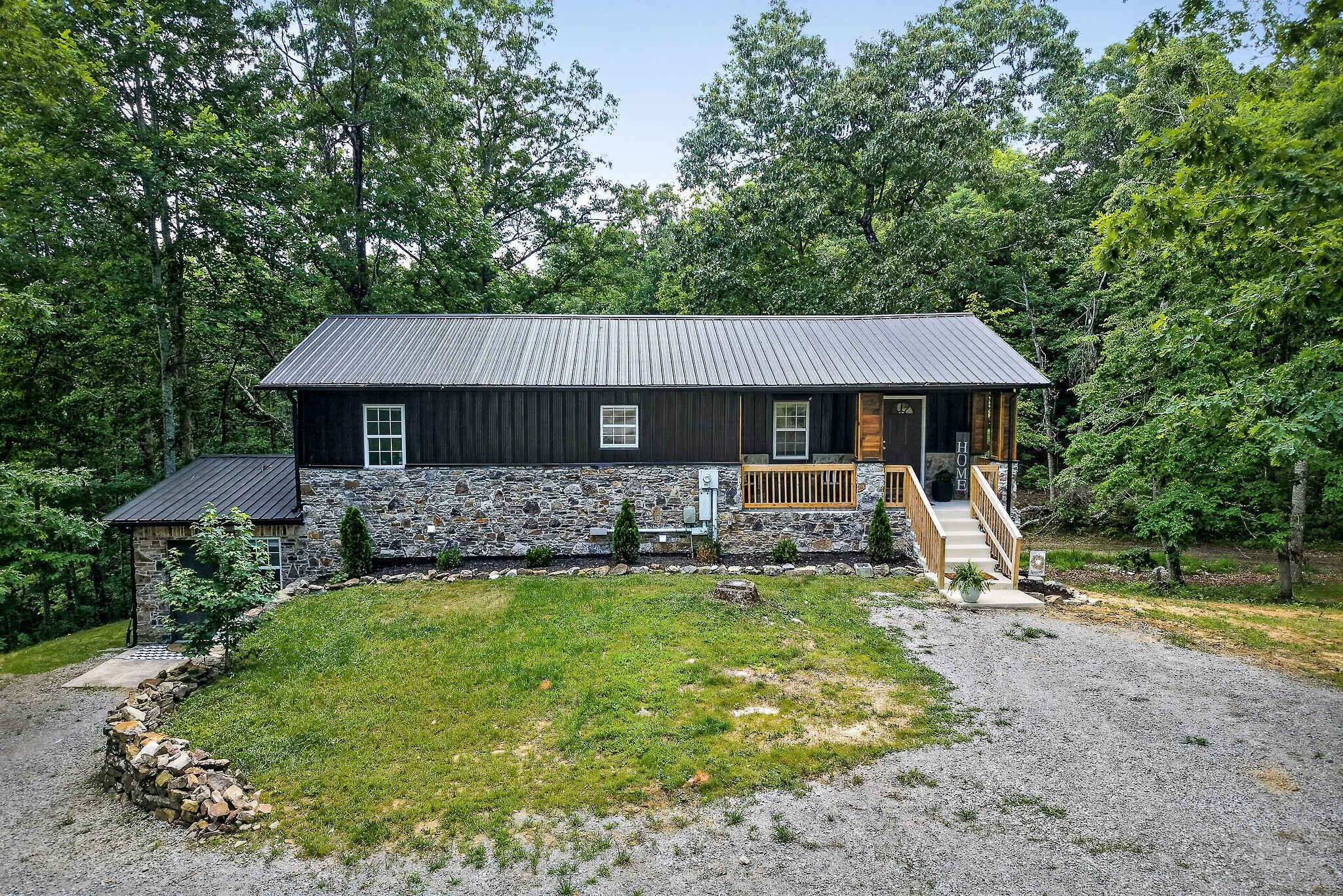 9388 Harrison Ferry Road McMinnville, TN 37110 - Photo 1 of 41 a front view of a house with garden and trees