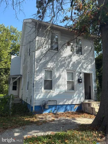 a view of house with a yard garage and sitting area