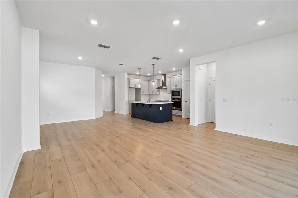 5836 Native Oak Street Mount Dora, FL 32757 - Photo 13 of 39 a view of kitchen and kitchen with furniture wooden floor and window