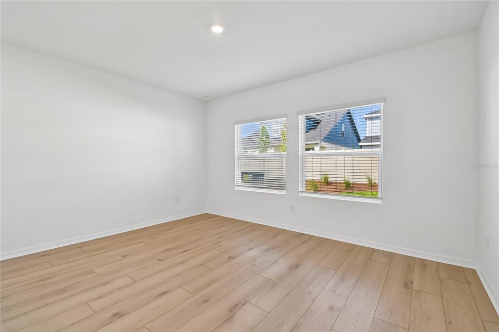 5836 Native Oak Street Mount Dora, FL 32757 - Photo 15 of 39 a view of empty room with wooden floor and fan