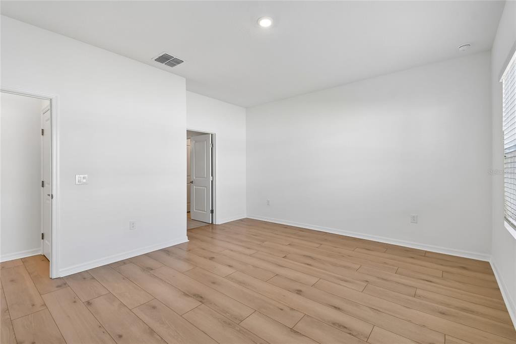 5836 Native Oak Street Mount Dora, FL 32757 - Photo 16 of 39 a view of an empty room and wooden floor