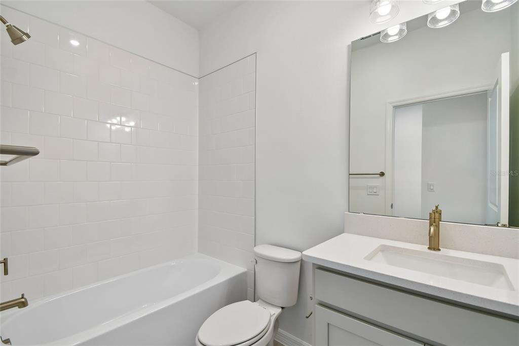 5836 Native Oak Street Mount Dora, FL 32757 - Photo 25 of 39 a bathroom with a sink toilet vanity and bathtub
