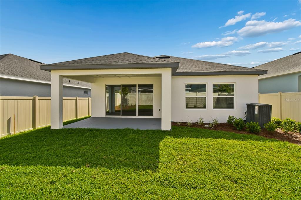 5836 Native Oak Street Mount Dora, FL 32757 - Photo 34 of 39 a view of a house with a yard